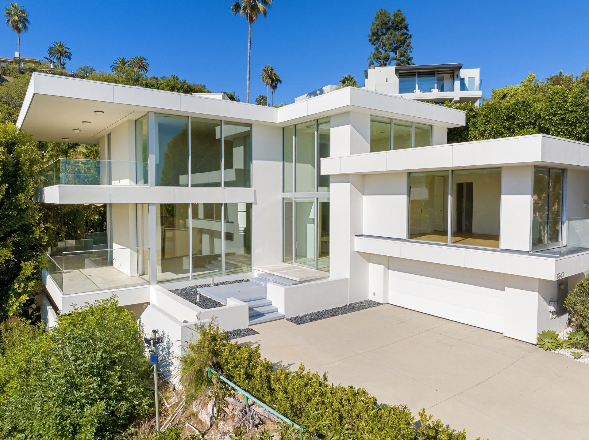 Contemporary hillside home with glass windows Contemporary hillside home with glass windows